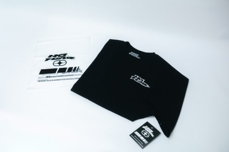 Retail-ready black tee with custom hang tag and printed neck label, finished in-house in Naples, FL